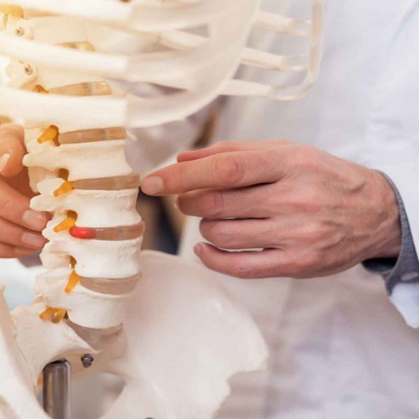 Doctor Showing Vertebrae Of Spine Chiropractic Care Henry Chiropractic 1602 N 9th Ave Pensacola FL 32503 850 435 7777 https   drcraighenry.com  600x600 1