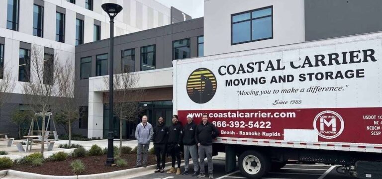 Coastal Carrier Moving Storage crew standing beside a moving truck outside a commercial building 768x360